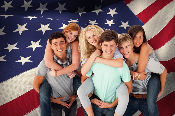 Teenagers giving their friends piggyback ride — Stock Photo, Image
