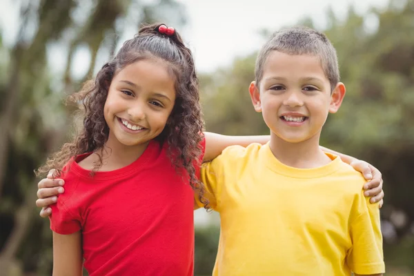 Cute pupils smiling at camera outside — Stock Photo, Image