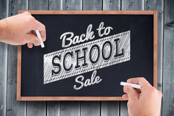 Composite image of business man writing with chalk — Stock Photo, Image