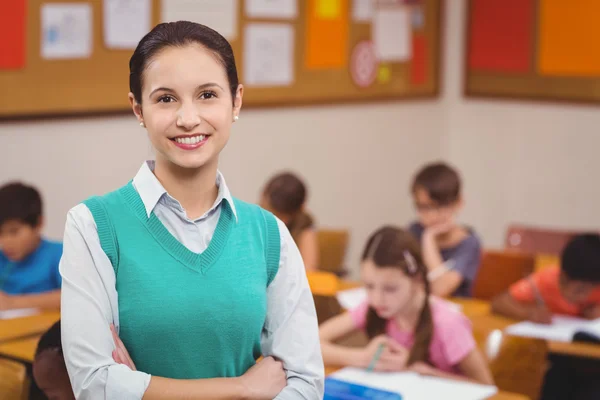 Teacher smiling at camera in classroom — Stock Photo, Image