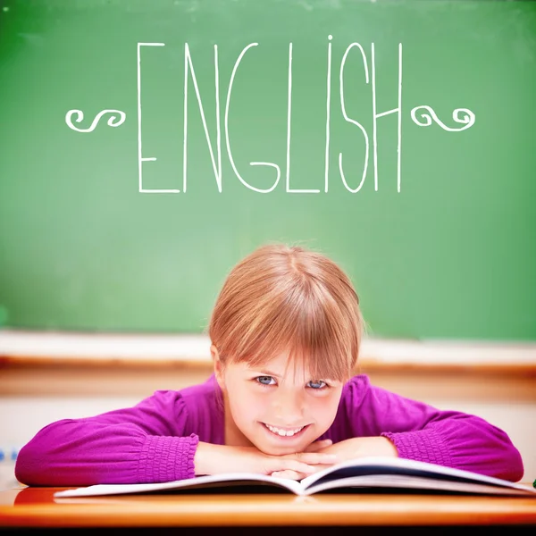 English against cute pupil sitting at desk — Stock Photo, Image