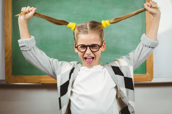 Pupil pulling her hair in classroom — Stock Photo, Image