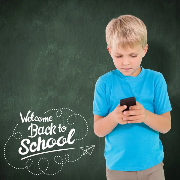 Imagen compuesta de niño lindo usando teléfono inteligente —  Fotos de Stock