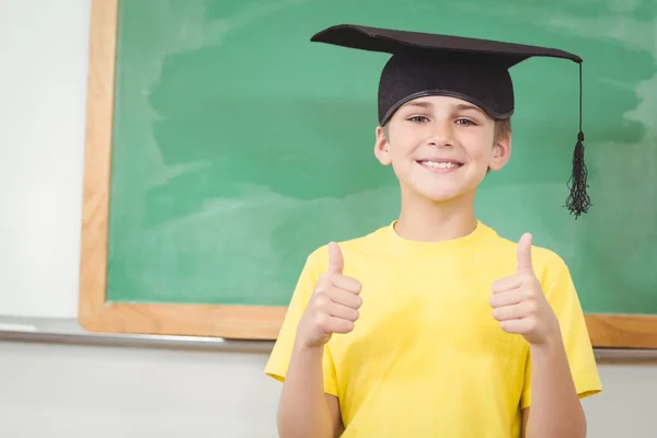 Pupil with mortar board doing thumbs up — Stock Photo, Image