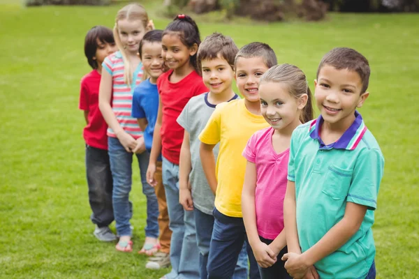 Cute pupils smiling at camera outside — Stock Photo, Image