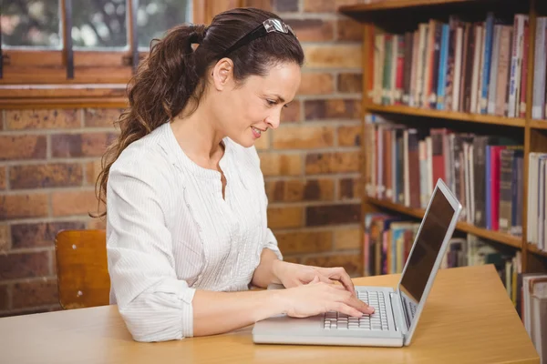 Teacher using laptop in her office — Stock Photo, Image