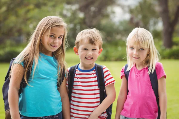 Smiling classmates with schoolbags — Stock Photo, Image