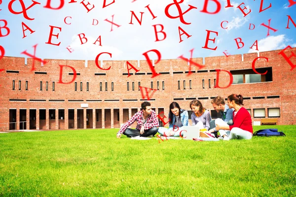 Students using laptop in lawn — Stock Photo, Image