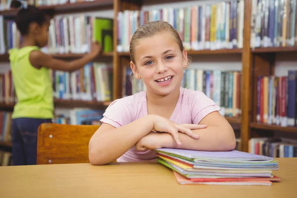 Smiling student sitting at a table — Stock Photo, Image