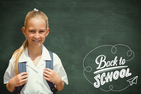 Cute pupil smiling at camera by the school bus — Stock Photo, Image