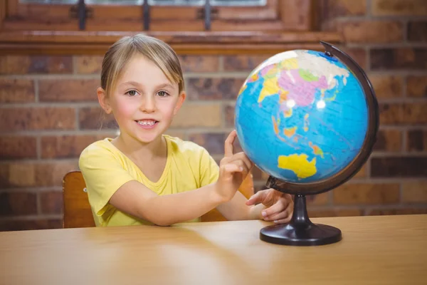 Student pointing at a globe — Stock Photo, Image