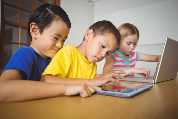 Alumnos en clase utilizando ordenador portátil y tableta — Foto de Stock