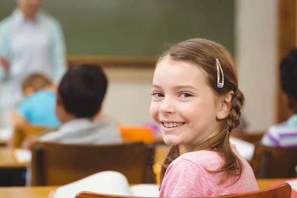 Pupil smiling at camera during class — Stock Photo, Image