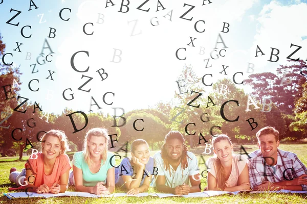 Letters against students studying outside on campus — Stock Photo, Image