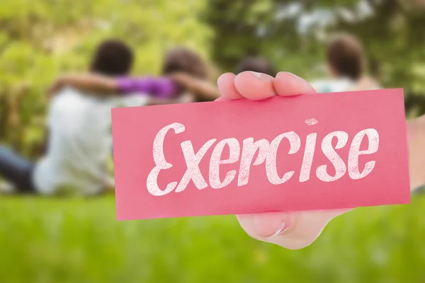 Exercise against children sitting with arms around at park — Stock Photo, Image