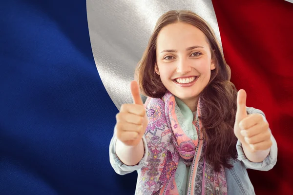 Composite image of woman showing thumbs up — Stock Photo, Image