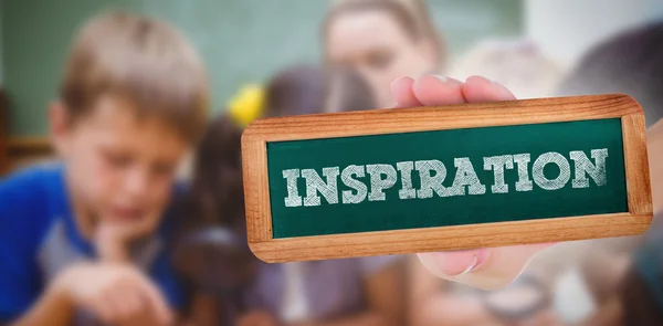 Inspiration against cute pupils looking through magnifying glass — Stock Photo, Image