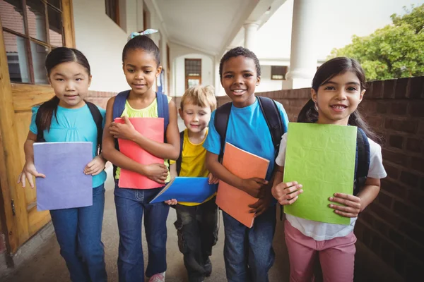 Cute pupils holding notebooks — Stock Photo, Image