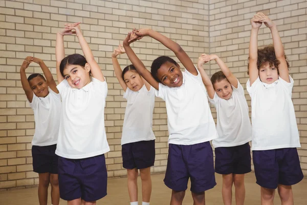 Happy students stretching out together — Stock Photo, Image