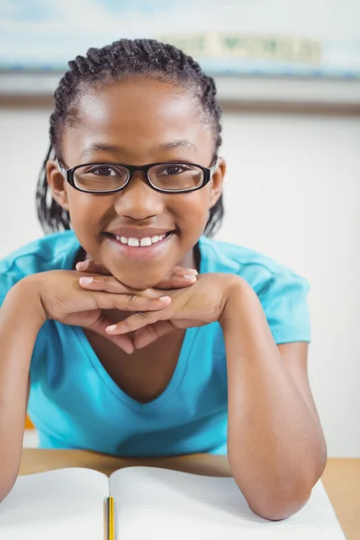 Cute pupil sitting at her desk — Stock Photo, Image