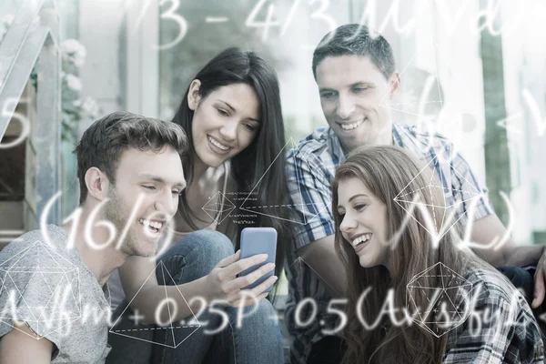 Students looking at smartphone outside on campus — Stock Photo, Image