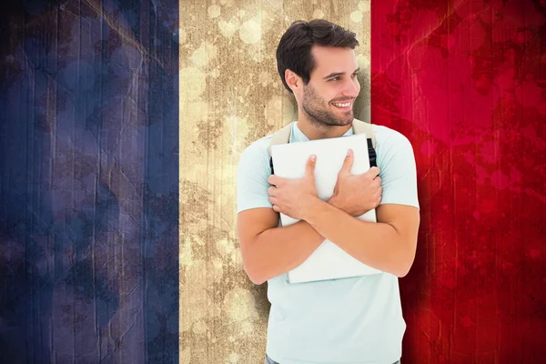 Composite image of student holding laptop — Stock Photo, Image