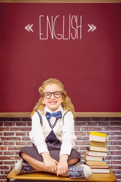 Word english and cute pupil sitting on table — Stock Photo, Image