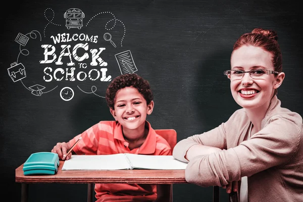 Composite image of teacher helping pupil — Stock Photo, Image