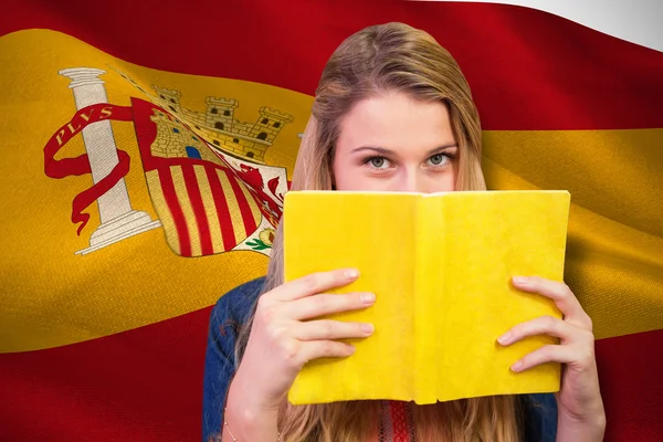 Student covering face with book — Stock Photo, Image