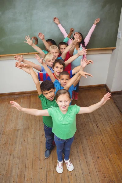 Students with arms raised together — Stock Photo, Image