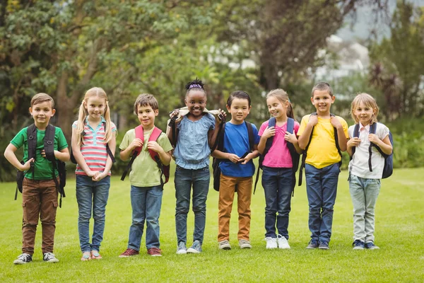 Cute pupils with schoolbags outside — Stock Photo, Image