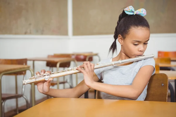 Student using a flute in class — Stock Photo, Image