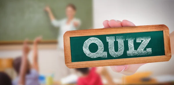 Word quiz and hand showing chalkboard — Stock Photo, Image