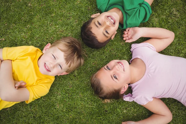 Smiling pupils lying on the ground Stock Image