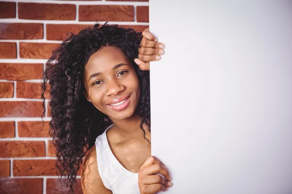 Mujer sonriente sosteniendo pizarra blanca — Foto de Stock