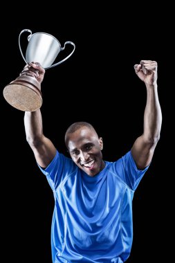 sportsman cheering while holding trophy clipart