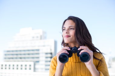 Pretty brunette holding binoculars  clipart
