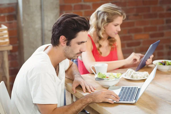 Colleagues using technologies in office — Stock Photo, Image