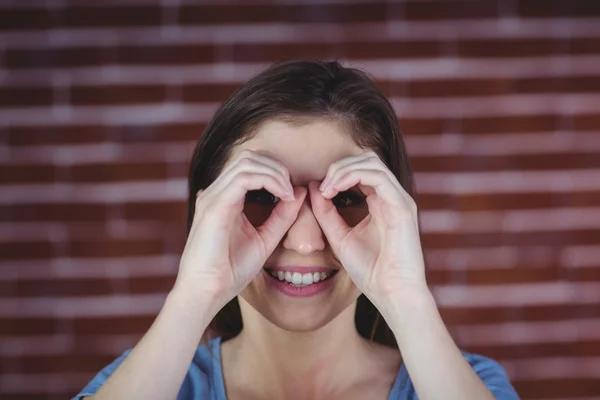 Woman holding hands as binoculars — Stock Photo, Image