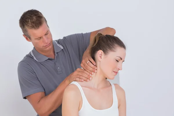 Doctor examining his patient neck — Stock Photo, Image