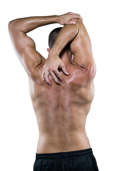 Shirtless athlete stretching elbow — Stock Photo, Image