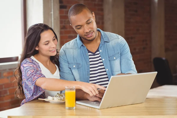 Business people pointing towards laptop — Stock Photo, Image