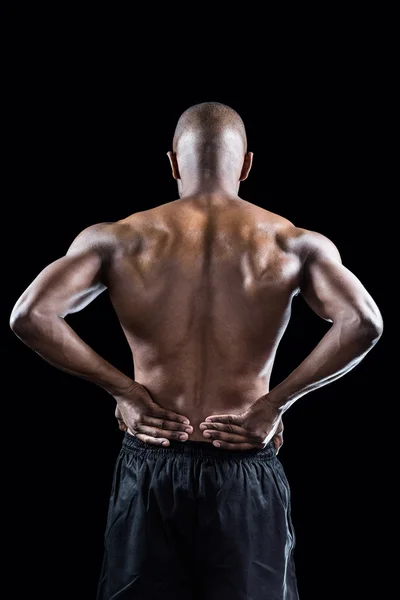Atleta muscular estiramiento con la mano en la cadera —  Fotos de Stock