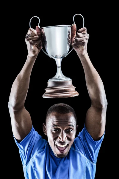 Athlete cheering while holding trophy — Stock Photo, Image