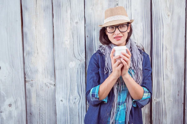 Happy hipster holding cup