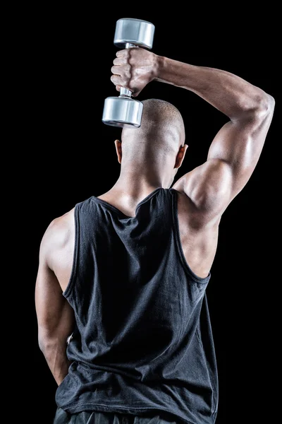 Hombre musculoso haciendo ejercicio con la mancuerna — Foto de Stock