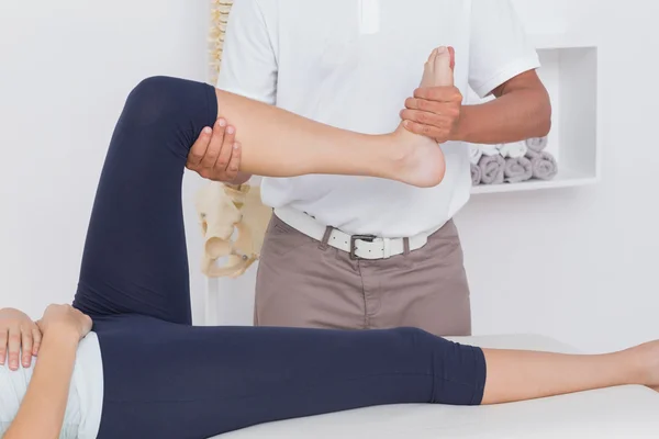 Physiotherapist doing leg massage to patient — Stock Photo, Image