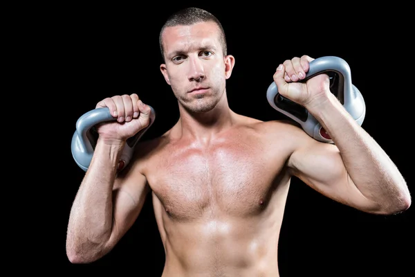 Confident shirtless athlete holding kettlebell — Stock Photo, Image