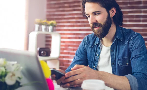 Creative businessman using mobile phone — Stock Photo, Image