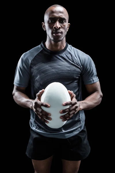Determined rugby player holding ball — Stock Photo, Image